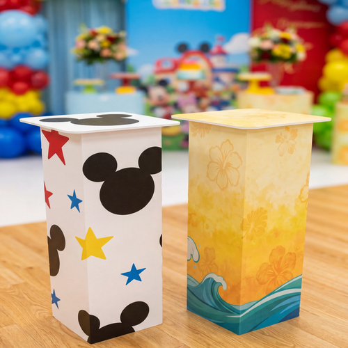 Two decorative paper lanterns on a wooden surface with a colorful background.